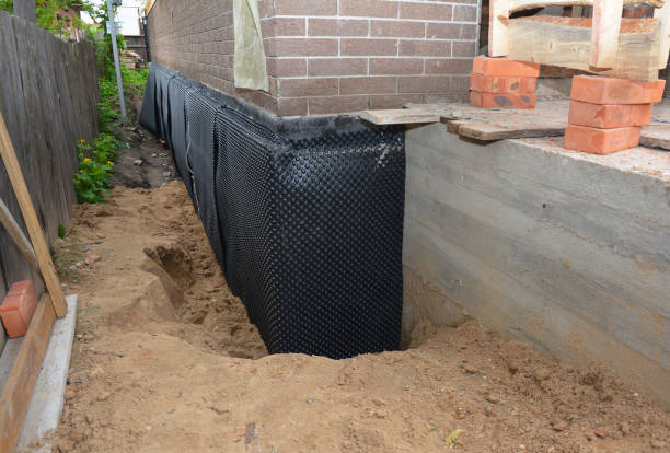 Happy homeowners after waterproofing job in Tellico Plains
